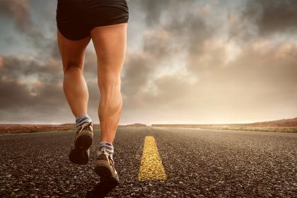 Picture of a man's thighs while running on an empty road